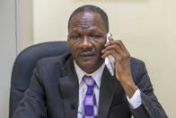 Judge Yvenne Tibeau talks on his phone at his office at the courthouse in Port-au-Prince, Haiti, Monday, Jan. 25, 2021. Tibeau joined a group of judges who went on strike last year after a well-respected lawyer and head of the bar association in Port-au-Prince, was fatally shot at his home. While the case remains unsolved and Tibeau has since returned to work, he still worries about his safety and said the government has not responded to his repeated requests for a police escort. (AP Photo/Dieu Nalio Chery)