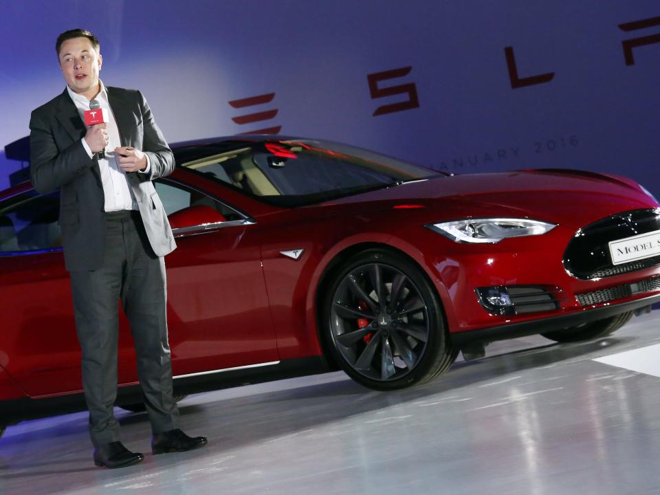 Tesla Motors CEO Elon Musk speaks to the media next to its Model S in Hong Kong on January 25, 2016.