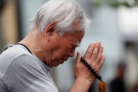 A man prays for victims of the torched Kyoto Animation building in Kyoto