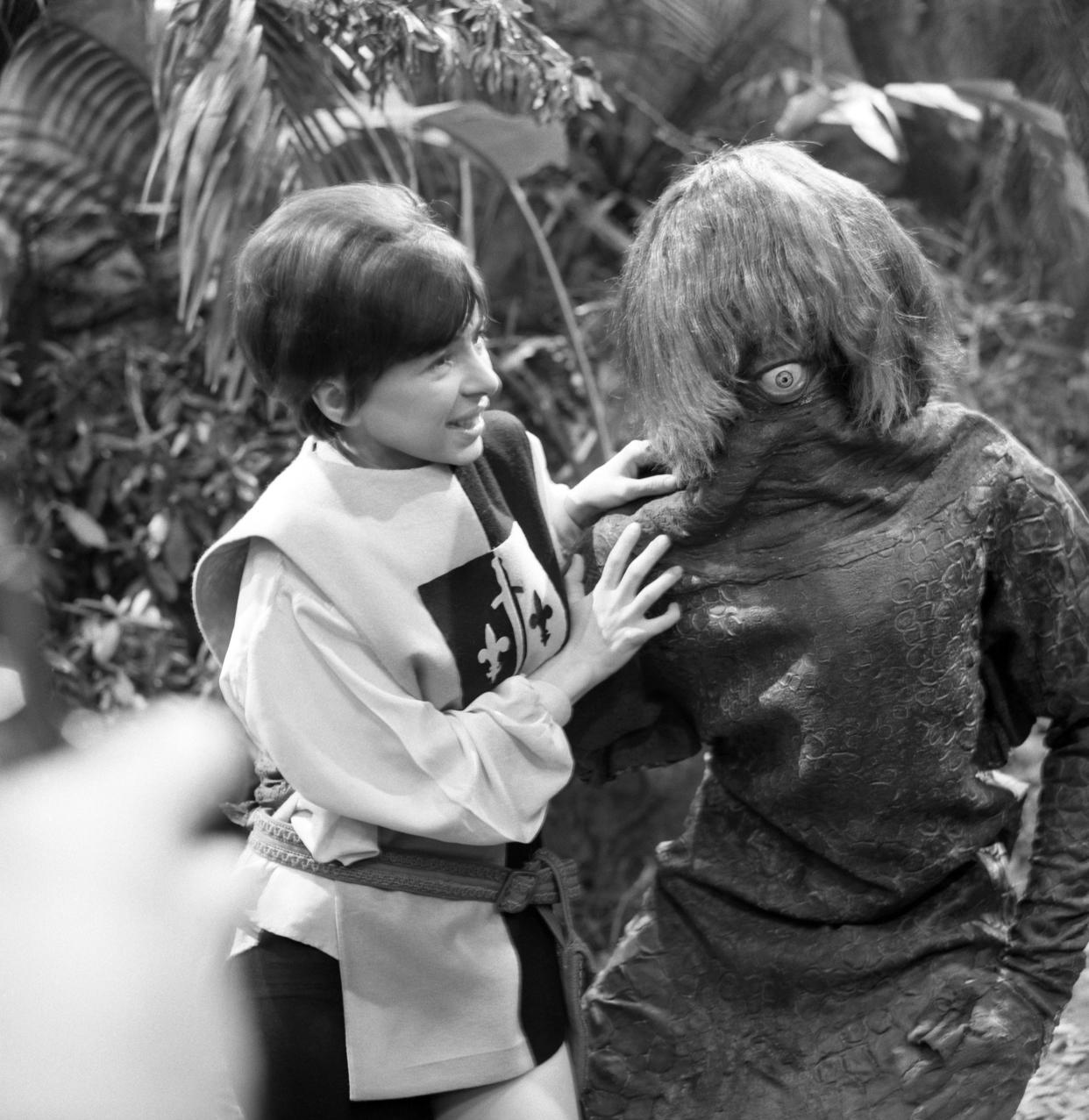 Actress Jackie Lane, who plays new assistant Dodo in the sci-fi series Doctor Who. She is pictured with a Monoid monster (played by Raymond Byrom), a reptilian one-eyed race of sub-humans.   (Photo by PA Images via Getty Images)