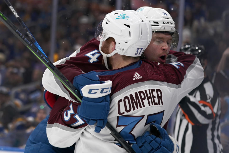 Colorado Avalanche's J.T. Compher (37) is congratulated by Bowen Byram (4) after scoring during the third period in Game 6 of an NHL hockey Stanley Cup second-round playoff series against the St. Louis Blues Friday, May 27, 2022, in St. Louis. (AP Photo/Jeff Roberson)