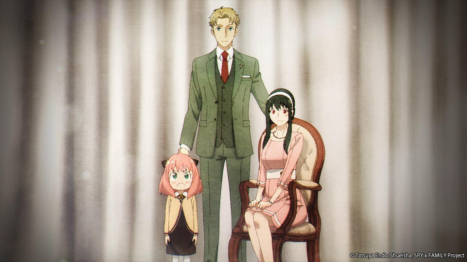A family portrait of the Forger Family with Loid in the middle Yor on the right and Anya on the left