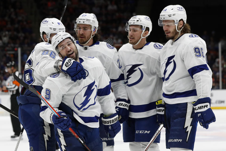 Tampa Bay Lightning center Tyler Johnson (9) celebrates his third-period goal against the New York Islanders with right wing Nikita Kucherov (86), defenseman Ryan McDonagh (27), left wing Ross Colton (79) and defenseman Mikhail Sergachev (98) in Game 4 of an NHL hockey semifinal Saturday, June 19, 2021, in Uniondale, N.Y. (AP Photo/Jim McIsaac)