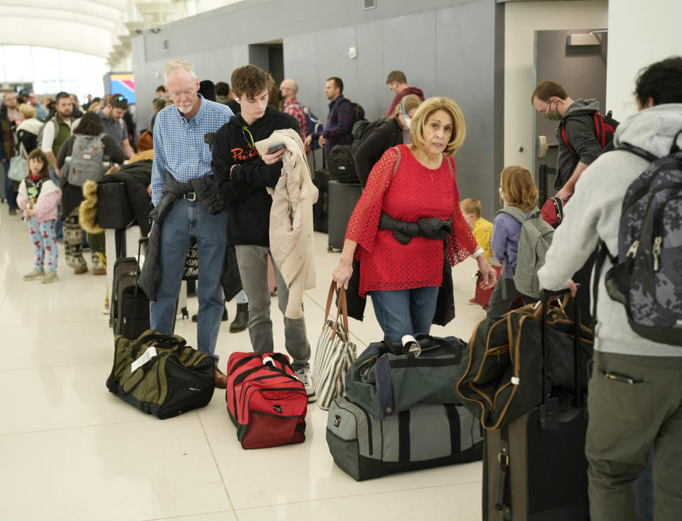Travelers wade through the line to drop off bags at the Southwest Airlines check-in counter at Denver International Airport, Dec. 27, 2022. (AP Photo/David Zalubowski, File)
