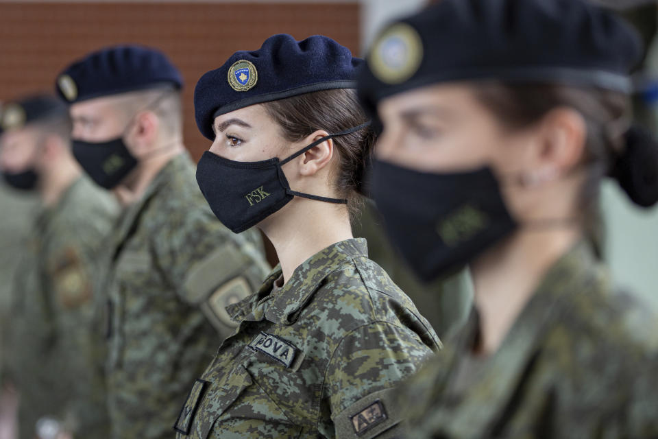 Kosovo Security Force (KSF) members wearing protective face masks line up during a peacekeeping mission deployment ceremony held at the army barracks in Pristina, Tuesday, March 9, 2021. Kosovo is sending a military platoon to Kuwait, its first ever involvement in an international peacekeeping mission. A ceremony was held Tuesday at the army barracks in the capital, Pristina, with the presence of top country leaders and western military attaches. Kosovo is sending the military unit following a request from the U.S. Central Command. (AP Photo/Visar Kryeziu)