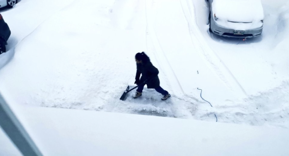 Jon Reyes shared a photo of his wife shovelling snow in their driveway  (Jon Reyes/Twitter)