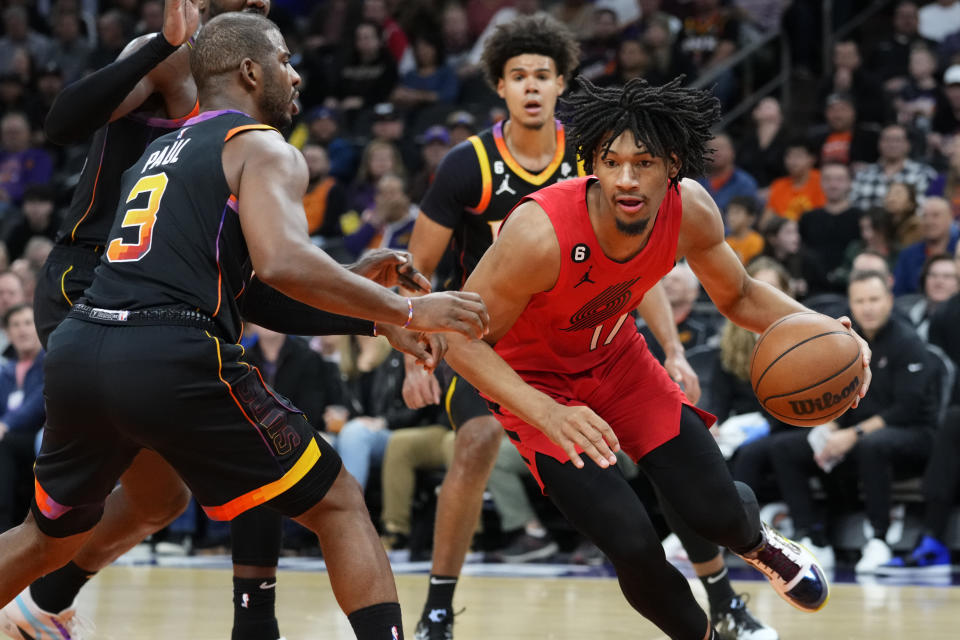 Portland Trail Blazers guard Shaedon Sharpe (17) drives as Phoenix Suns guard Chris Paul (3) defends during the first half of an NBA basketball game, Friday, Nov. 4, 2022, in Phoenix. (AP Photo/Matt York)