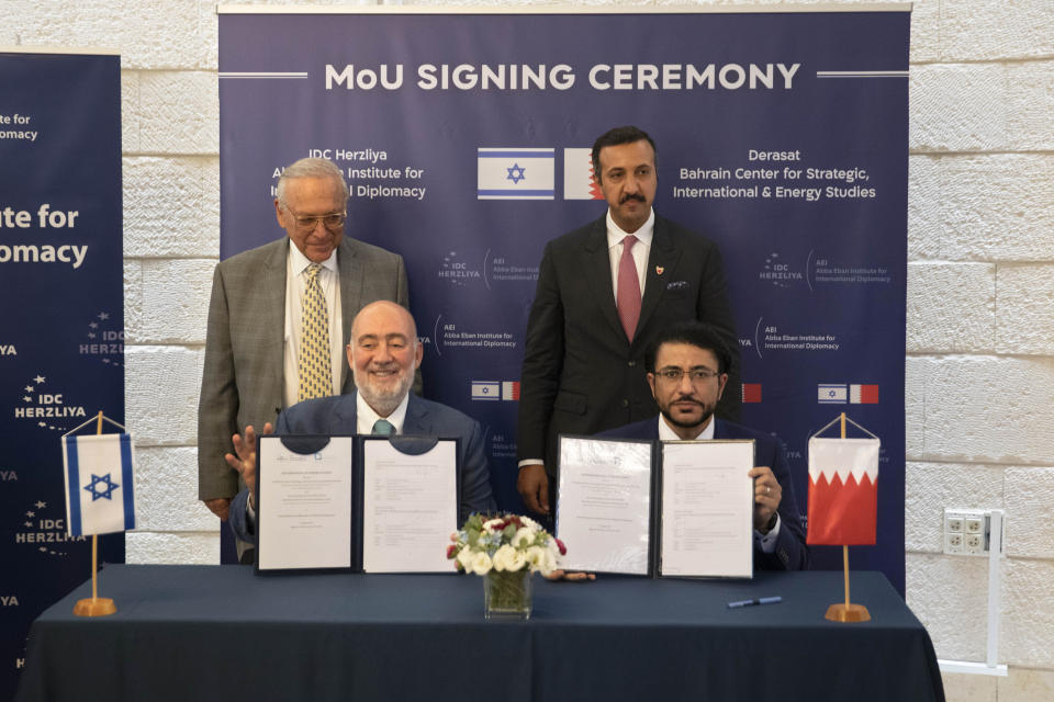 Israeli Prof. Uriel Reichman, left, Israeli Ron Prosor of the Abba Eban Institute for international diplomacy, center left, Bahraini Dr. Shaikh Abdulla bin Ahmed Al Khalifa and Bahraini Dr. Hamad Ebrahim Al Abdulla of the Derasat Baharain center for strategic, international, and energy studies, show a signed memorandum during a ceremony at the Interdisciplinary Center in the central Israeli city of Herzliya, Wednesday, Aug. 11, 2021. The Bahraini delegation is visiting Israel as the two countries strengthen ties after agreeing to normalize relations last year. (AP Photo/Sebastian Scheiner)
