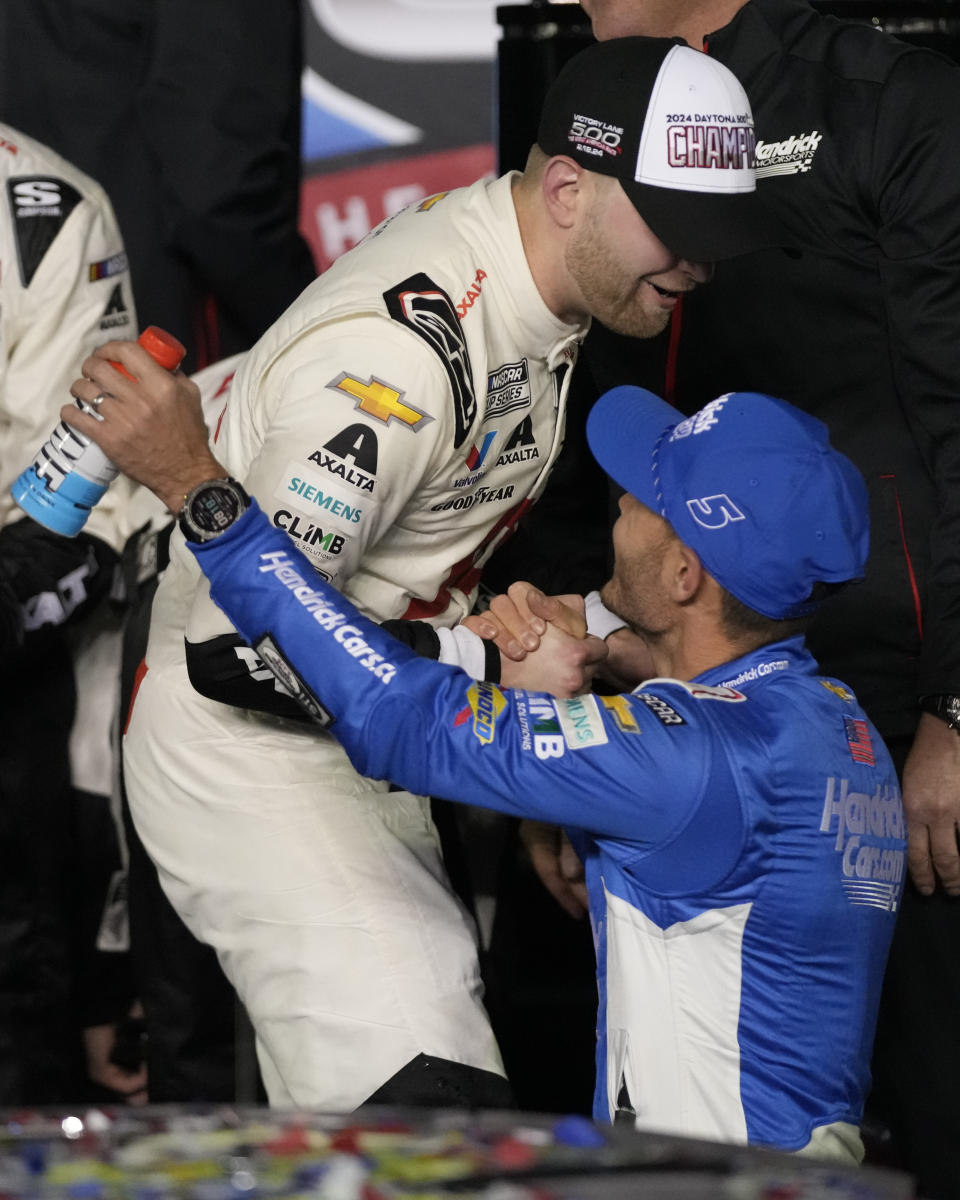 William Byron, left, winner of the NASCAR Daytona 500 auto race is congratulated by Kyle Larson in Victory Lane at Daytona International Speedway, Monday, Feb. 19, 2024, in Daytona Beach, Fla. (AP Photo/John Raoux)