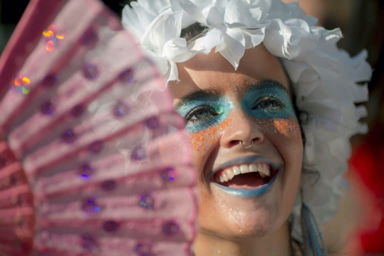 A member of the "Ceu Na Terra" (Heaven on Earth) group dances in a street party a week ahead of the main carnival event in Rio de Janeiro