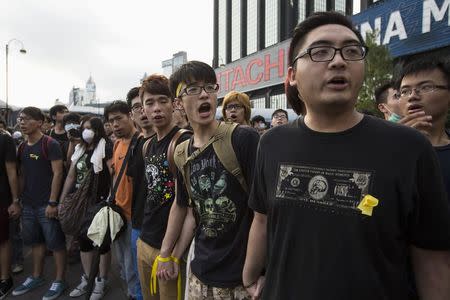 Student protesters shout slogans outside the Golden Bauhinia Square, venue of the official flag-raising ceremony for celebrations of China's National Day, in Hong Kong October 1, 2014. REUTERS/Tyrone Siu