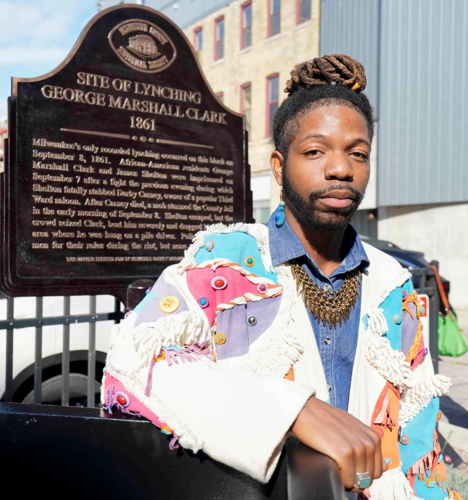Tyrone Macklee Randle stands in front of a historical marker designating the spot of the 1861 lynching of George Marshall Clark at 220 E. Buffalo St. in Milwaukee's Third Ward on Oct. 11, 2023. “I’m feel full,” he said, knowing it was a full-circle moment to get the marker erected. He led the efforts to get a headstone for Clark's unmarked grave in Forest Home Cemetery.