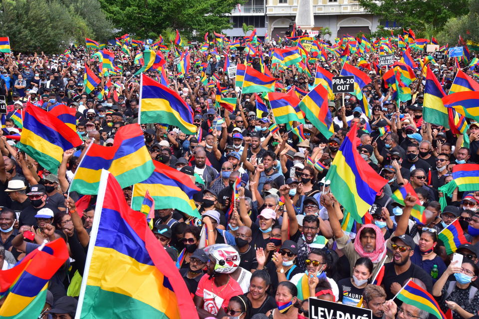 Tens of thousands of people protest in Port Louis, Mauritius, Saturday Aug. 29, 2020, over the government's slow response to an oil spill from a grounded Japanese ship and the alarming discovery of dozens of dead dolphins . (Beekash Roopun/L'express Maurice via AP)