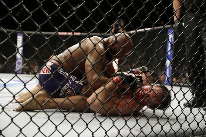 Yoel Romero, top, pins Tim Kennedy during their fight, Saturday, Sept. 27, 2014, in Las Vegas. Romero won via TKO. (AP Photo/John Locher)