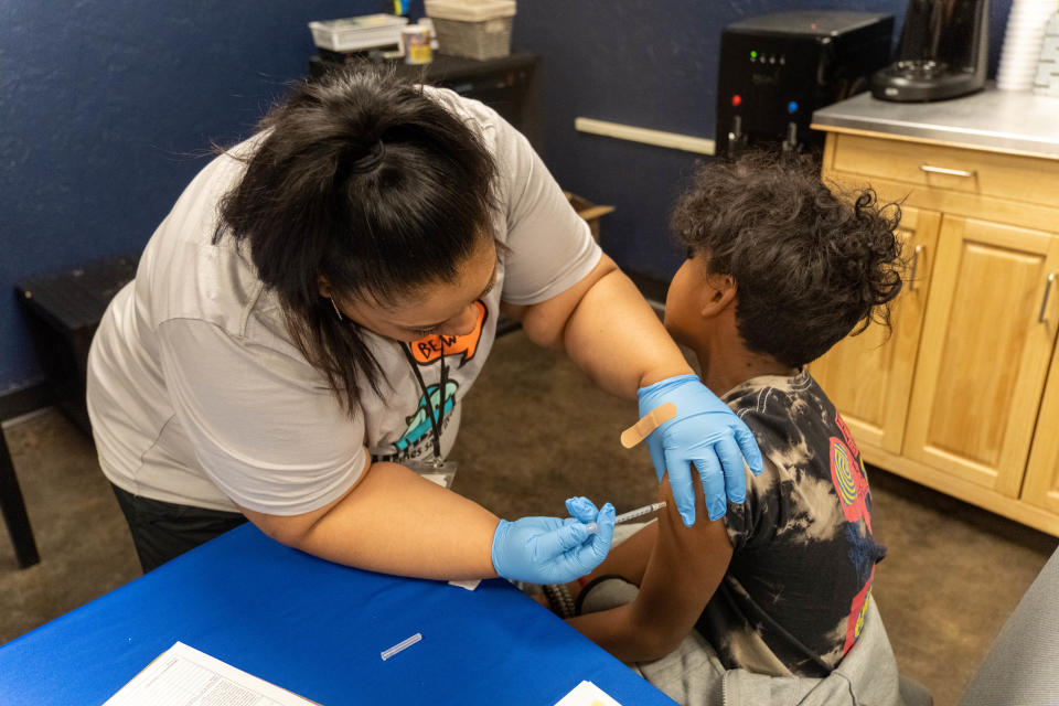 A nurse gives a young boy a COVID-19 booster Saturday at the Spring into Wellness Health Community Health and Resource Fair held at the Southwest Church of Christ in Amarillo.