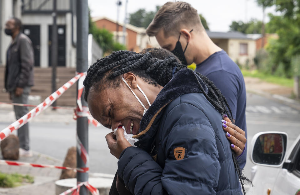 A woman weeps outside the historical home of Anglican Archbishop Desmond Tutu, in Soweto, Johannesburg, South Africa, Monday, Dec. 27, 2021. South Africa's president says Tutu, South Africa's Nobel Peace Prize-winning activist for racial justice and LGBT rights and the retired Anglican Archbishop of Cape Town, died Sunday at the age of 90. (AP Photo/Shiraaz Mohamed)