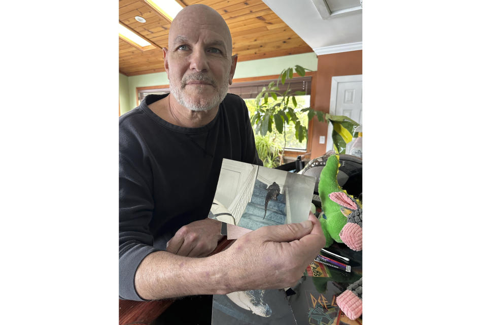 Tony Cavallaro shows photos of his alligator, Albert, on March 19, 2024, in Hamburg, N.Y. Albert was seized by the Department of Environmental Conservation in mid-March 2024. (AP Photo/Carolyn Thompson)