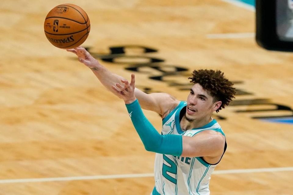 Charlotte Hornets guard LaMelo Ball passes against the Miami Heat Sunday. Ball had five assists but also five turnovers in Miami’s 121-111 win.