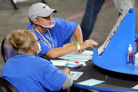 Maricopa County ballots cast in the 2020 general election are examined and recounted by contractors working for Florida-based company, Cyber Ninjas, Thursday, May 6, 2021 at Veterans Memorial Coliseum in Phoenix. The audit, ordered by the Arizona Senate, has the U.S. Department of Justice saying it is concerned about ballot security and potential voter intimidation arising from the unprecedented private recount of the 2020 presidential election results. (AP Photo/Matt York, Pool)