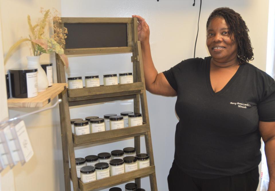 Miranda Berry poses with her products in Berry Bomb Candle Co.