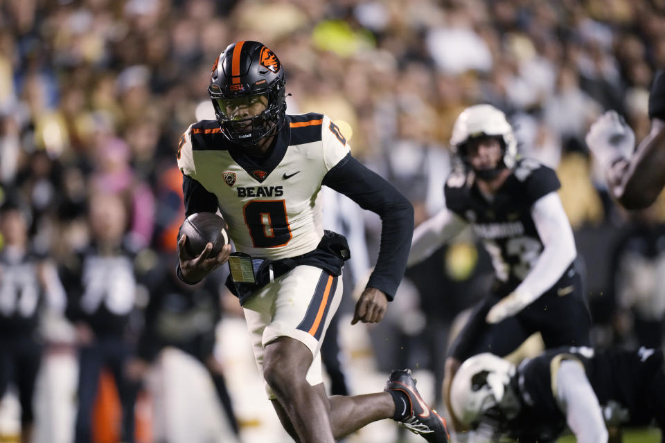 Oregon State quarterback Aidan Chiles runs with the ball during the first half of the team's NCAA college football game against Colorado on Nov. 4, 2023, in Boulder, Colo. Michigan State is breaking in a new football coach and quarterback this year. The Spartans may benefit from how familiar the pivotal people in the program are because they both were at Oregon State last season. Former Beavers coach Jonathan Smith was hired in late November and quarterback Chiles joined him less than a month later. (AP Photo/David Zalubowski, File)