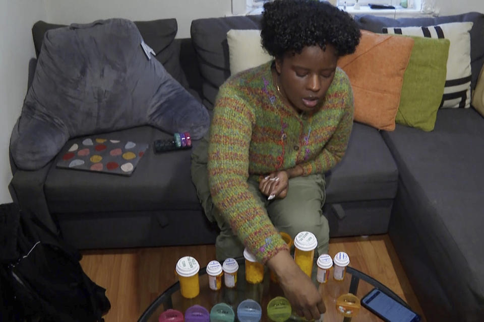 Jazmin Evans, a student at Temple University, prepares her post-kidney transplant medications at home in Philadelphia on Feb. 16, 2024. Evans had been waiting for a new kidney for four years when her hospital revealed shocking news: She should have been put on the transplant list in 2015 instead of 2019 — and a racially biased organ test was to blame. (AP Photo/Tassanee Vejpongsa)