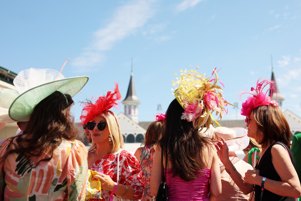 LOUISVILLE, KENTUCKY - MAY 05: Spectators wearing festive hats look on in the paddock ahead of the 149th running of the Kentucky Derby at Churchill Downs on May 05, 2023 in Louisville, Kentucky. (Photo by Michael Reaves/Getty Images)