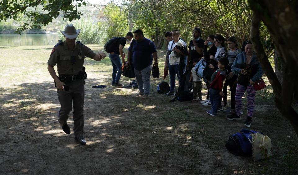 Texas public safety officers work with migrants who crossed the border and turned themselves in Del Rio, Texas in June 2021.