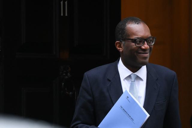 FTSE 100 Britain&#39;s Chancellor of the Exchequer Kwasi Kwarteng holds a folder reading 