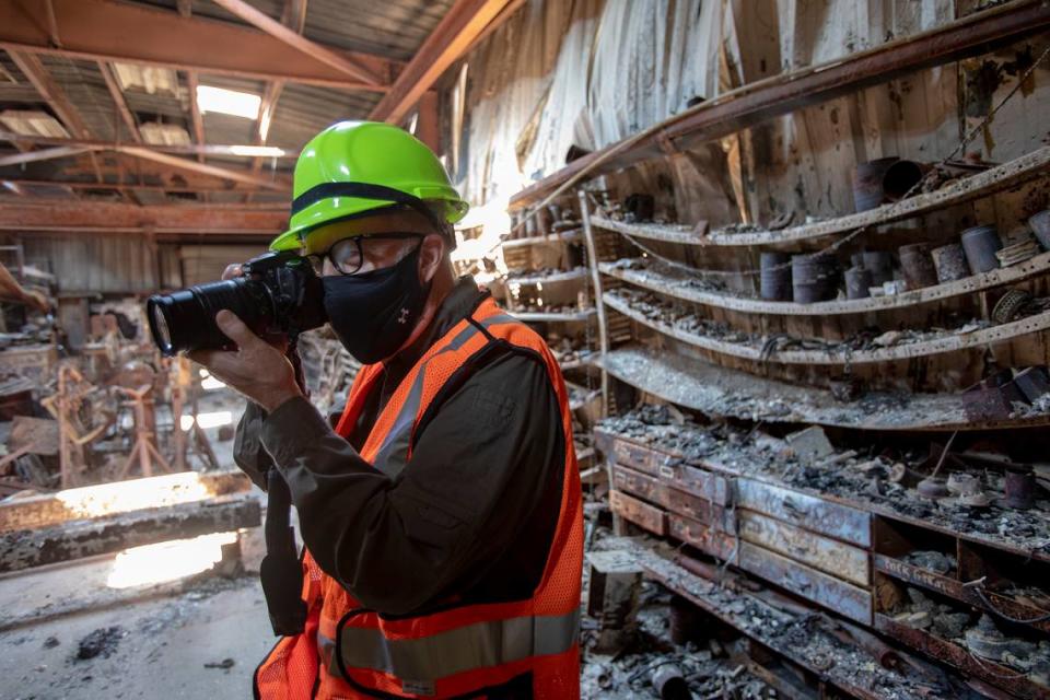 Charlie Crabb, former director of the Swanton Pacific Railroad, documents the railroad’s gutted car house destroyed by the CZU Complex fire, Monday, Aug., 24, 2020. The facility is owned by Cal Poly San Luis Obispo near Davenport, Calif.
