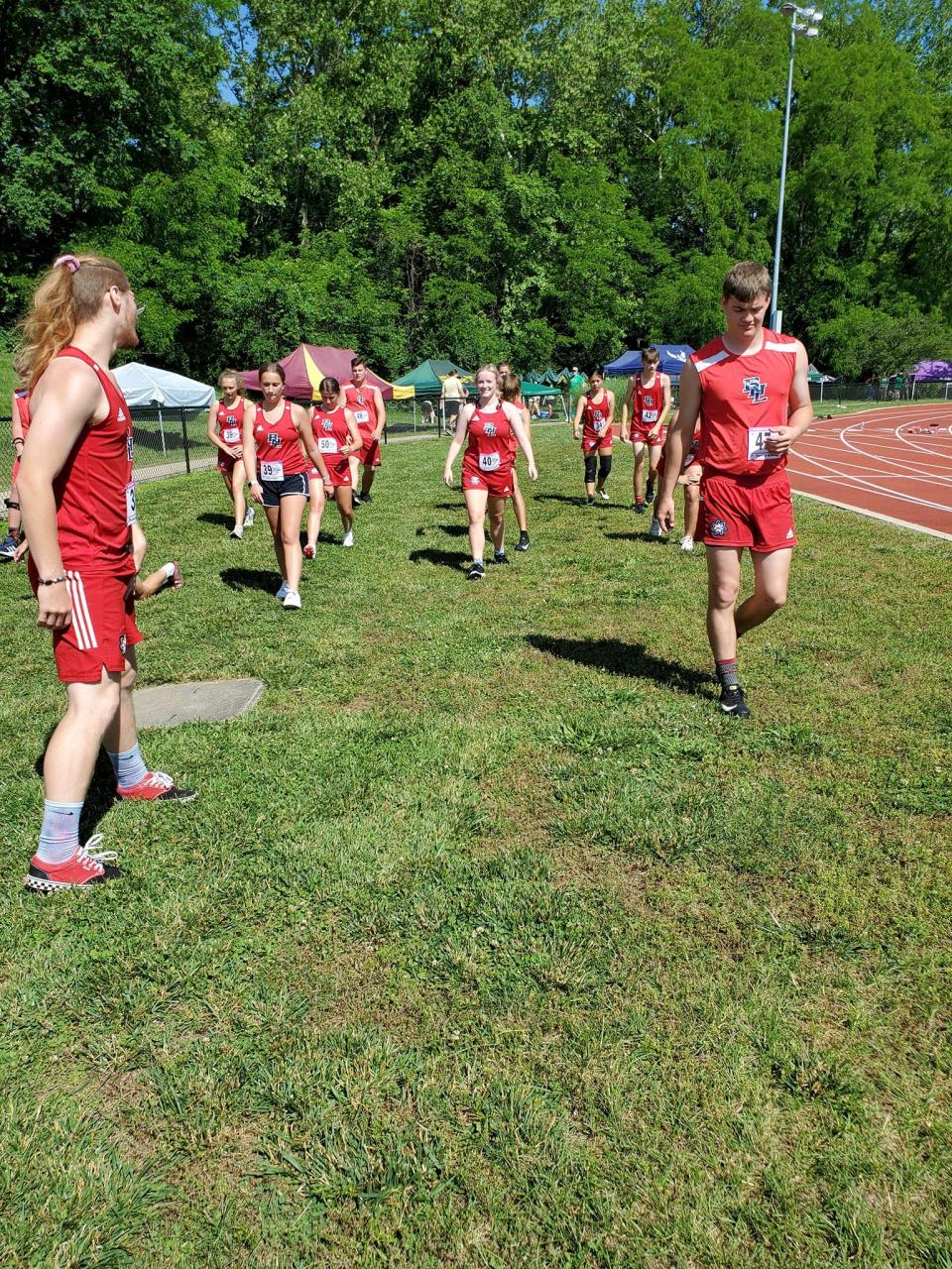 BNL seniors Gunner Connaughton (left) and Tanner Robbins (right) lead the BNL Unified Track & Field team to the track Saturday at the IHSAA State Finals. The Stars won the state title by two points over Lafayette Jefferson.