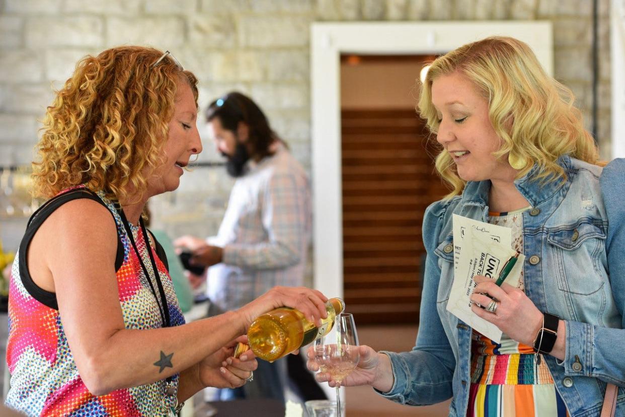 Wine consultant Melissa Kadow pours a glass of Rose of Cabernet Franc for Pamela Shirtz during Uncorked at Gideon Owen Wine Company on May 19.