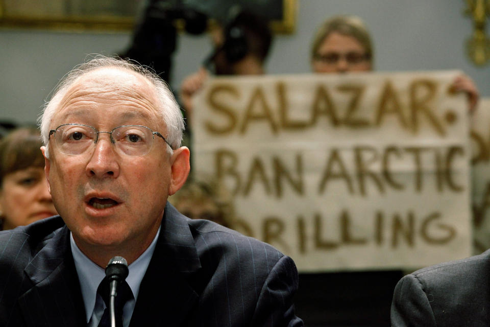 Greenpeace demonstrators hold up signs behind Interior Secretary Ken Salazar as he testifies before the House Committee on Natural Resources in May 2010, five weeks after the BP Deepwater Horizon rig explosion and oil spill. (Photo: Chip Somodevilla via Getty Images)