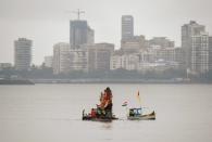 <p>Indian devotees carry a statue of elephant-headed Hindu god Lord Ganesha for immersion in the Arabian sea in Mumbai on September 15, 2016. During the eleven-day Ganesh Festival Hindu devotees bring home idols of Lord Ganesha and offer prayers in temporary temples in order to invoke his blessings for wisdom and prosperity, culminating with the immersion of the idols in bodies of water, including the ocean on the last day. </p>