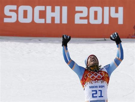 Norway's winner Kjetil Jansrud celebrates on podium during a flower ceremony after the men's alpine skiing Super-G competition during the 2014 Sochi Winter Olympics at the Rosa Khutor Alpine Cente February 16, 2014. REUTERS/Mike Segar (