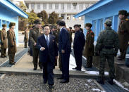 In this photo released by the South Korean Unification Ministry, North Korean chief delegate Won Tong Yon, center left, walks with other delegates after crossing a military demarcation line, which has separated the two Koreas since the Korean War, for a meeting with South Korean delegates at the border village of Panmunjom, South Korea, Friday, Feb. 14, 2014. The rival Koreas sat down Friday for a second round of talks this week at a border village as the North's calls for a delay of annual South Korea-U.S. military drills threaten plans for the resumption of emotional reunions of war-divided families. (AP Photo/South Korean Unification Ministry)