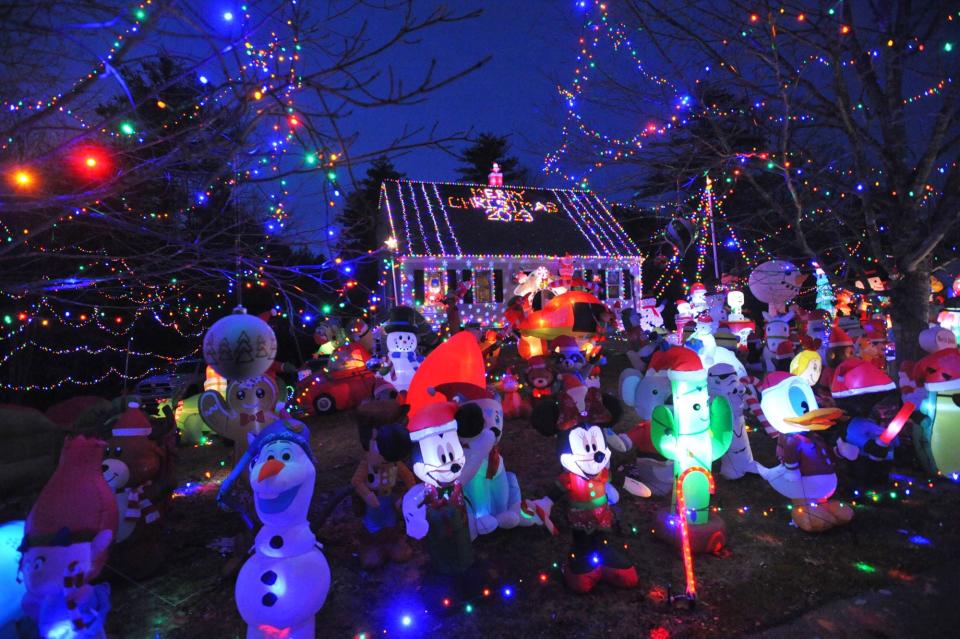 The Hanson home of Tim and Kim Young features more than 100 inflatable characters, plus music and lights.