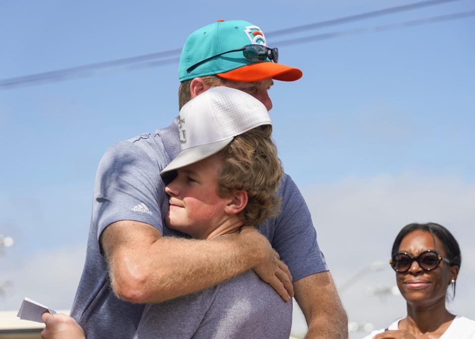 "I feel as if I have let my family, team, coaches and community down. I'm not trying to make excuses. Part of me knew this was wrong, but we did not do this out of hatred and we did not know the full horrific meaning of this word," said Hidden Oaks Middle School student McClain Lewis, who hugs his baseball coach after reading a public apology letter for his actions during the Martin County NAACP chapter's Unity Rally on Saturday, June 11, 2022, in Stuart. The event took place three weeks after six Hidden Oaks Middle School students were involved in a photo that spelled out a racial slur. 