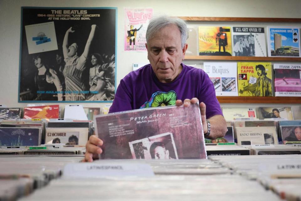 Yesterday and Today Records owner Evan Chern sorts records on display at his store on west Bird Road at 9274 SW 40th St. in Miami, Florida, Friday, Feb. 2, 2024. Y&T is the oldest independent record store in Miami-Dade County.