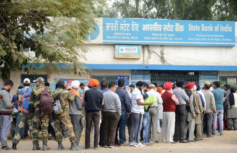 Villagers queue outside a bank in Khasa village, some 20kms from Amritsar, as they wait to deposit and exchange 500 and 1000 rupee notes on November 12, 2016