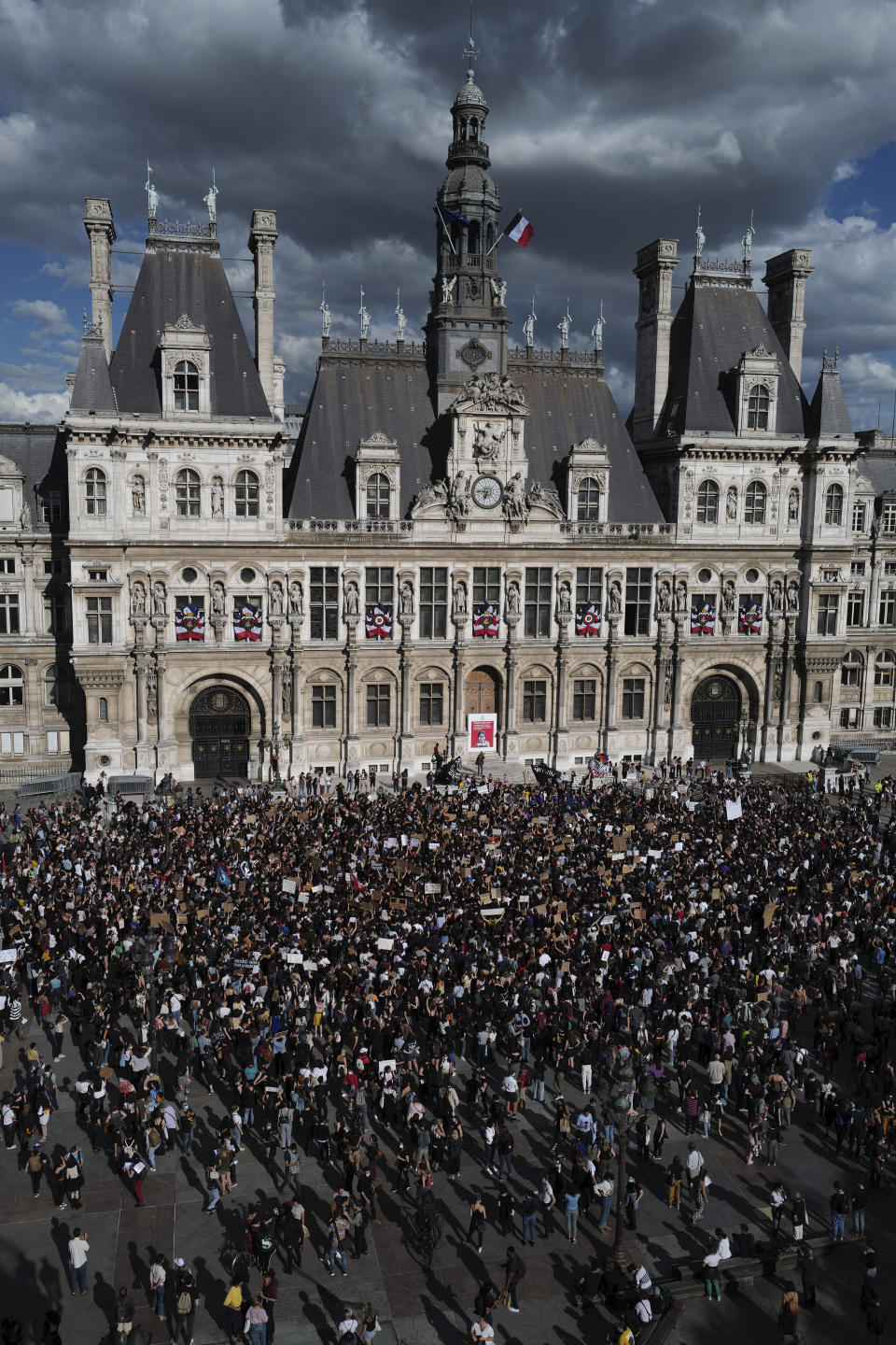 Women's rights activists protest against French President Emmanuel Macron's appointment of an interior minister who has been accused of rape and a justice minister who has criticized the #MeToo movement, in front of Paris city hall, in Paris, France, Friday, July 10, 2020. The French government said it remains committed to gender equality and defended the new ministers, stressing the presumption of innocence. Gerald Darmanin, Interior Minister, firmly denies the rape accusation, and an investigation is underway. New Justice Minister Eric Dupond-Moretti is a lawyer who has defended a government member accused of rape and sexual assault, and has ridiculed women speaking out thanks to the #MeToo movement. (AP Photo/Francois Mori)