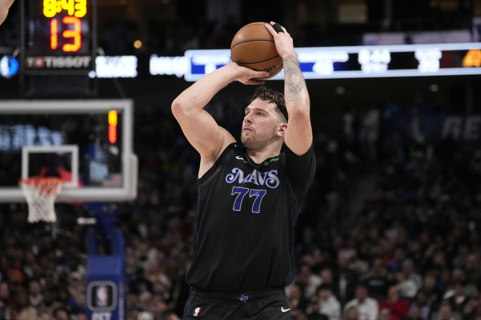 Dallas Mavericks' Luka Doncic shoots and sinks a three-point basket in the first half of an NBA basketball game against the Phoenix Suns in Dallas, Wednesday, Jan. 24, 2024. (AP Photo/Tony Gutierrez)