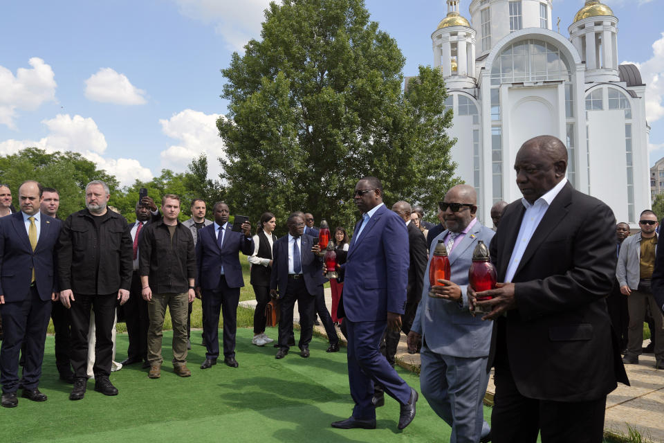 From right, South African President Cyril Ramaphosa, President of the Union of Comoros Azali Assoumani and Senegal's President Macky Sall attend a commemoration ceremony at a site of a mass grave in Bucha, on the outskirts of Kyiv, Ukraine, Friday, June 16, 2023. South African President Cyril Ramaphosa arrived in Ukraine on Friday as part of a delegation of African leaders and senior officials seeking ways to end Kyiv's 15-month war with Russia. (AP Photo/Efrem Lukatsky)