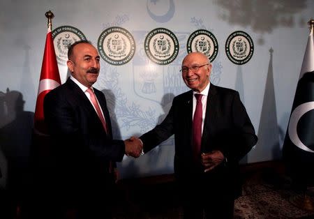 Turkish Foreign Minister Mevlut Cavusoglu (L) shakes hands with Adviser to Pakistan's Prime Minister on National Security and Foreign Affairs, Sartaj Aziz after their joint news conference at the Foreign Ministry in Islamabad, Pakistan, August 2, 2016. REUTERS/Faisal Mahmood