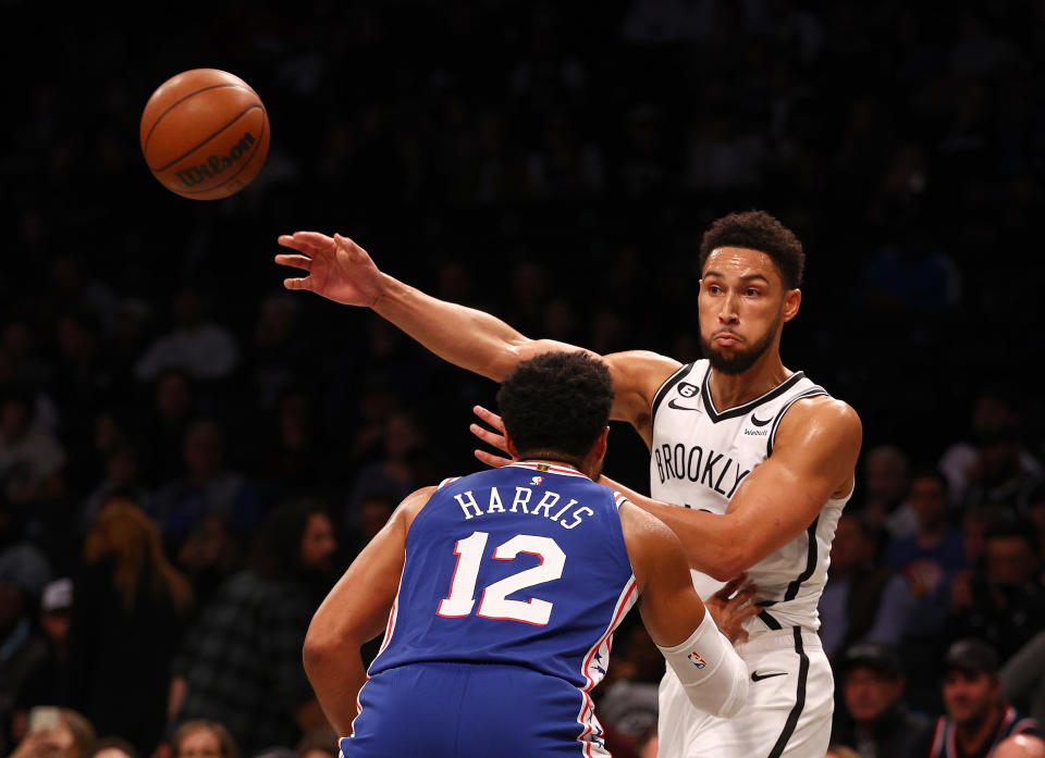 NEW YORK, NEW YORK - OCTOBER 03:  Ben Simmons #10 of the Brooklyn Nets passes the ball as Tobias Harris #12 of the Philadelphia 76ers defends in the first half during a preseason game at Barclays Center on October 03, 2022 in the Brooklyn borough of New York City. NOTE TO USER: User expressly acknowledges and agrees that, by downloading and or using this photograph, User is consenting to the terms and conditions of the Getty Images License Agreement. (Photo by Elsa/Getty Images)