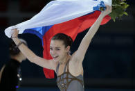 Adelina Sotnikova of Russia celebrates winning the women's free skate figure skating finals following the flower ceremony at the Iceberg Skating Palace during the 2014 Winter Olympics, Thursday, Feb. 20, 2014, in Sochi, Russia. (AP Photo/Ivan Sekretarev)