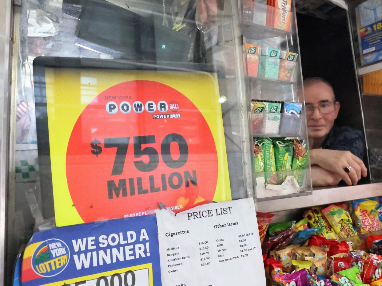 A Powerball lottery advertisement is displayed on a newsstand.