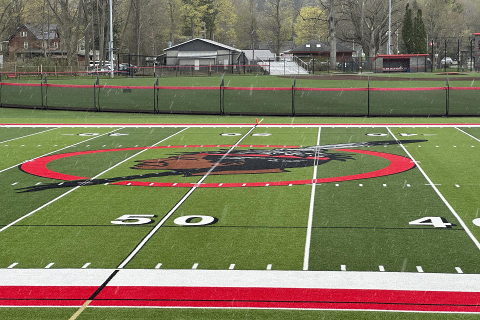 The logo of the Salamanca City Central School District is seen on the football field turf in Salamanca, N.Y., on April 18, 2023. The school district, located on Seneca Nation of Indians territory, may have to replace its logo after New York passed a ban on the use of Indigenous names, mascots and logos by public schools. (AP Photo/Carolyn Thompson)