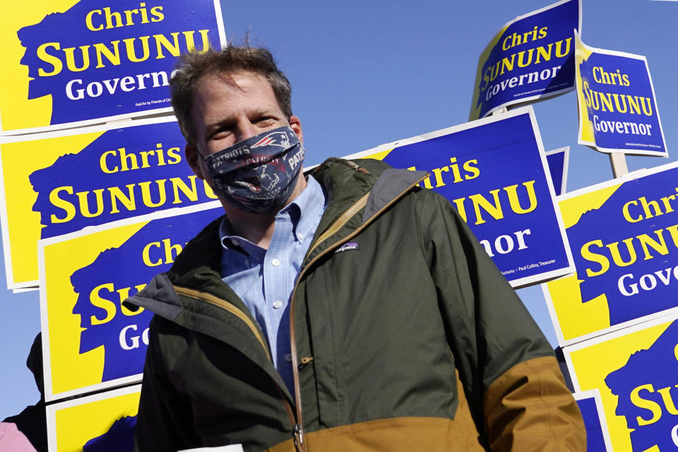 FILE— In this Nov. 3, 2020 file photograph, N.H. Gov. Chris Sununu stands with supporters at a polling station at Windham, N.H. High School in Windham. Sununu has been admitted to a hospital, Friday, Sept. 3, 2021, with flulike symptoms that have lasted for days and after having tested negative three times for COVID-19. (AP Photo/Charles Krupa, File)