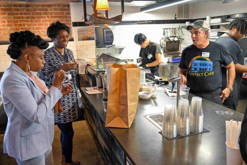 Customers Marla Howard, left, of Kansas City, Kansas, and Tracy Williams of Overland Park talked with Randy Ross as they sample brownies at Connect Cafe.